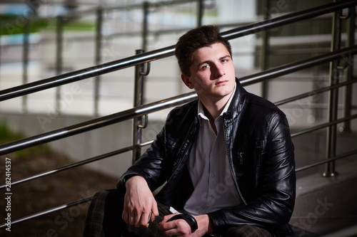 Closeup portrait of a serious guy in a leather jacket