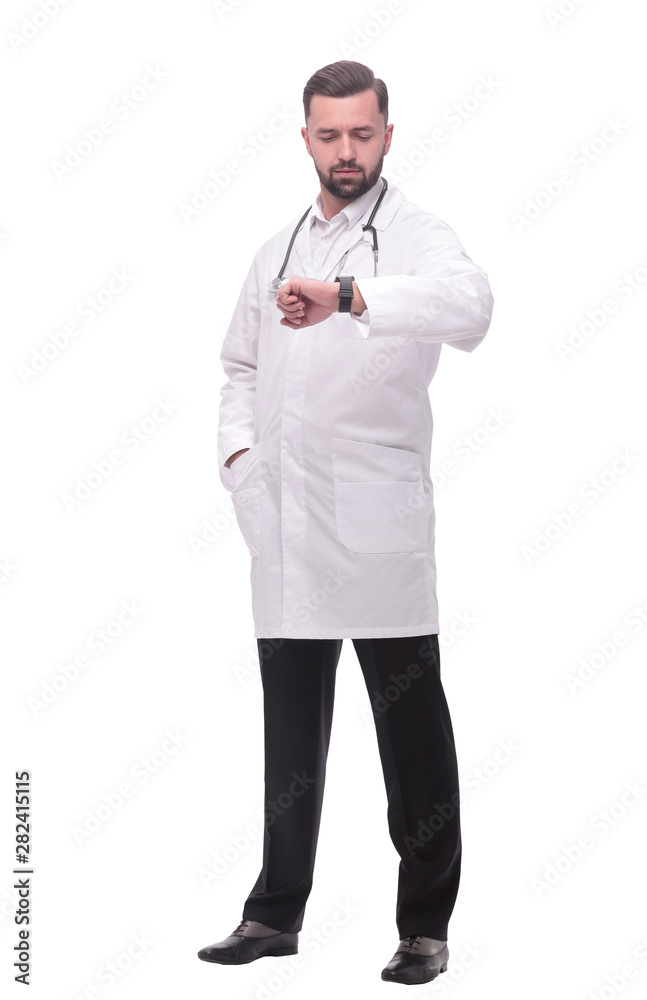 in full growth. medical doctor looking at his wrist watch in full growth. medical doctor looking at his wrist watch