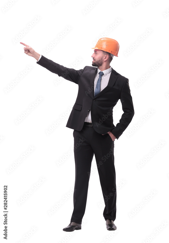 in full growth. young businessman in helmet pointing to copy space in full growth. young businessman in helmet pointing to copy space