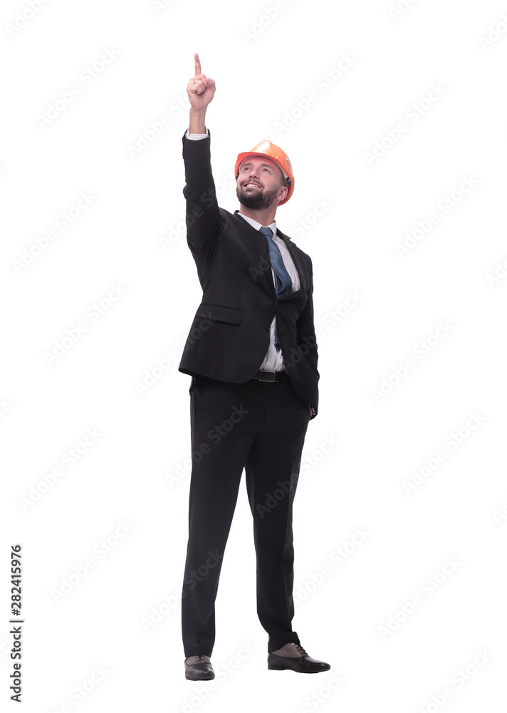 businessman in a helmet pointing up at a copy space businessman in a helmet pointing up at a copy space
