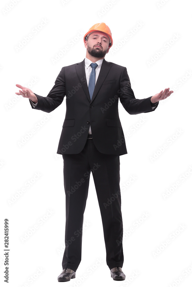 in full growth. young businessman in helmet looking far the upward in full growth. young businessman in helmet looking far the upward