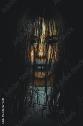 Scary witch with black eyes on dark background