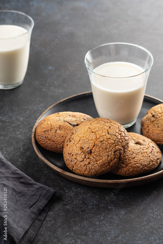 Chocolate chip cookies with milk on black table. Copy space. Chocolate chip cookies with milk on black table. Copy space.