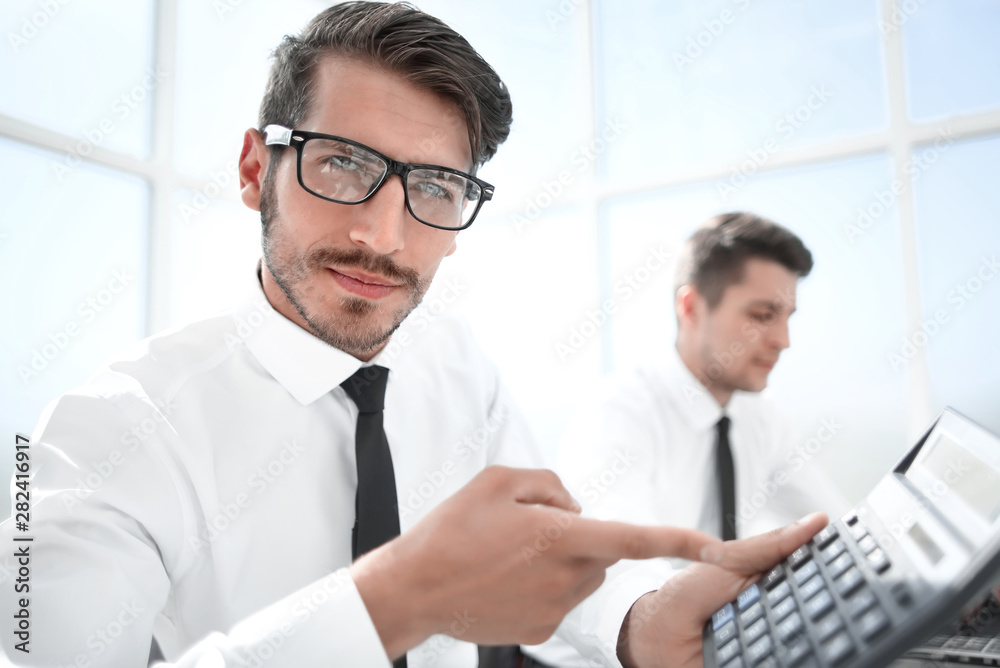 Smiling accountants discussing reports at the office Smiling accountants discussing reports at the office