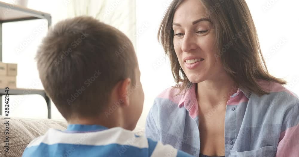 Happy mother talking with her little son at home Happy mother talking with her little son at home