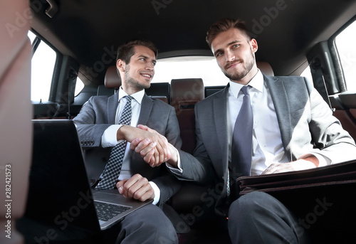 handshake business partners in the car.