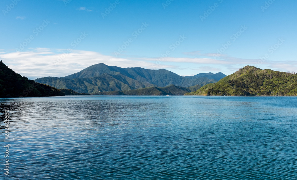 A low-level view of the beautiful and stunning Marlborough Sound and the surrounding hills at the top of the South Island, New Zealand on a sunny day.