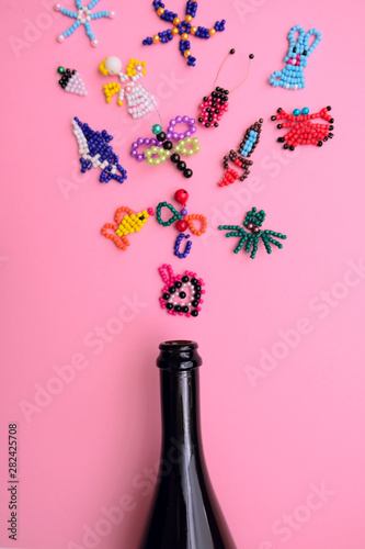 salute from children's crafts from beadsin flies out of a bottle of champagne