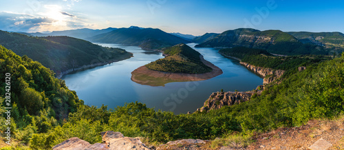 Bulgaria, Kardzhali dam, view of meander in Arda river, surrounded with green forest, summer time during sunset