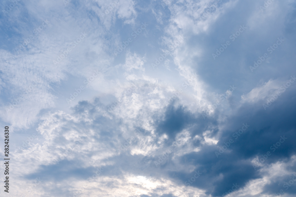 Fototapeta premium Air and fluffy clouds in the blue sky on a sunny day, background texture