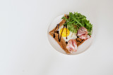 Galette bretonne  with fried eggs, arugula and bacon.