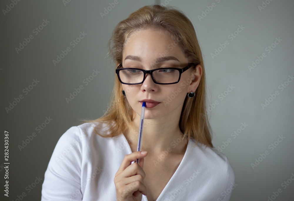 Portrait of the young thinking business woman looking down Portrait of the young thinking business woman looking down