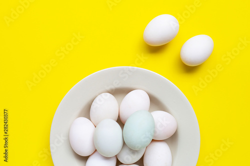 White eggs on yellow background.