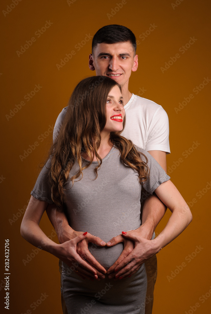 Fototapeta premium Beautiful young couple on yellow background