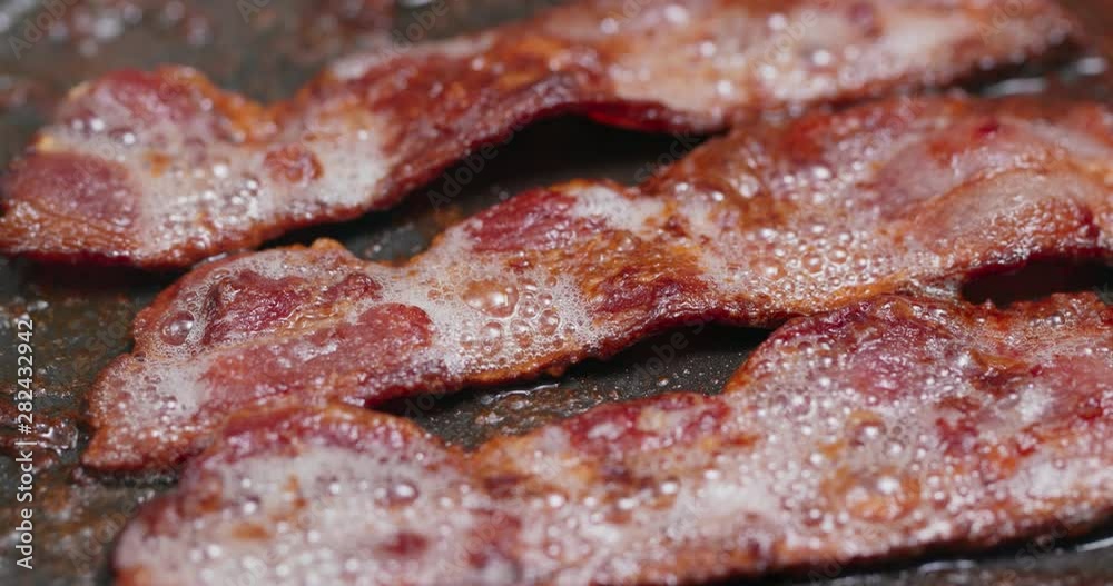 Cook with bacon on fry pan Cook with bacon on fry pan