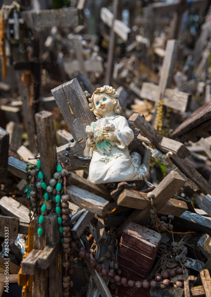 SIAULIAI, LITHUANIA - JULY 28, 2019: Old wooden sculptures on religious themes at the Hill of Crosses SIAULIAI, LITHUANIA - JULY 28, 2019: Old wooden sculptures on religious themes at the Hill of Crosses
