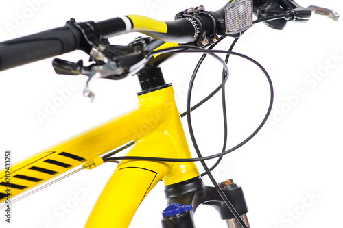Parts of yellow bicycle on a studio white background. Close up details