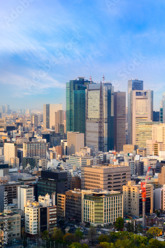 cityscape of tokyo city skyline in Aerial view with skyscraper, modern business office building with blue sky background in Tokyo metropolis city, Japan. © lukyeee_nuttawut