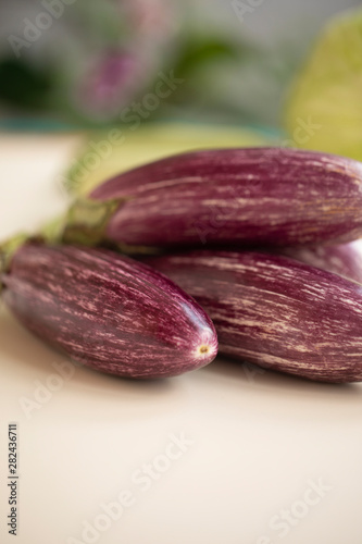 Wallpaper Mural Closeup view of small purple Asian eggplants, food background photography. Pile of fresh eggplants at Indian market, vegetarian food. Above small Asian purple eggplants, ecology and nature concept Torontodigital.ca
