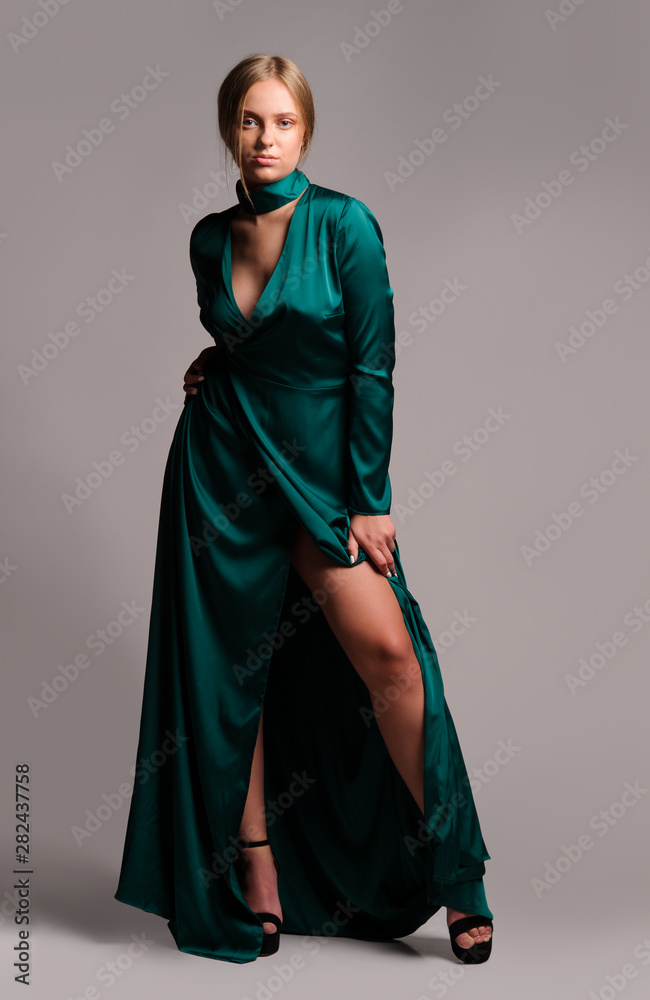Pretty girl in green dress. Studio picture, grey background Pretty girl in green dress. Studio picture, grey background