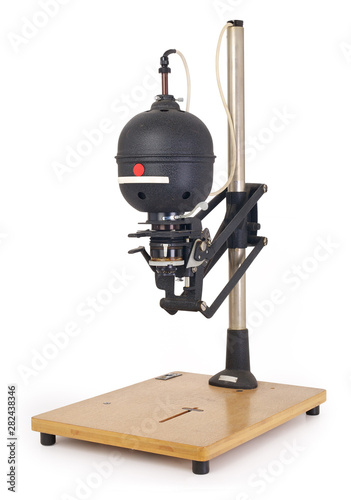 Vintage darkroom photo enlarger for projecting photo negatives, isolated on completely white background. Contains clipping path. photo