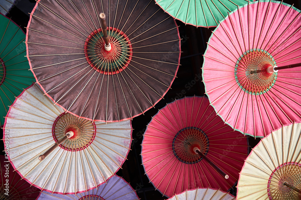 various colored umbrellas hanging from the ceiling