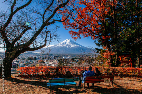 Mount Fuji and red maple tree with sweet couple at Chureito Pagoda Arakurayama Sengen Park - Fujiyoshida photo