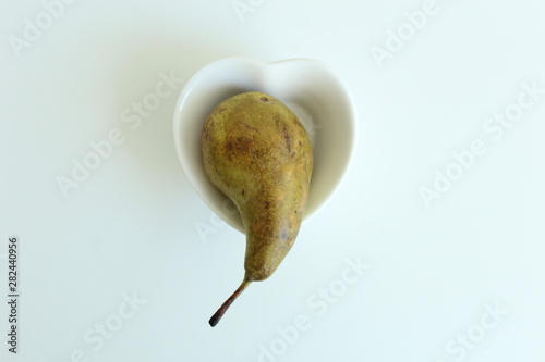 pear on heart shape plate.