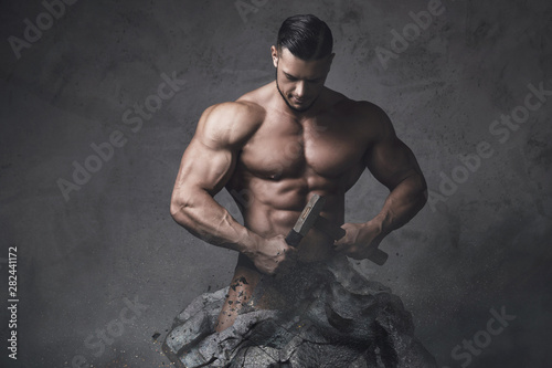  Bodybuilder made himself from the piece of stone. Concept of self improvement and bodybuilding progress. photo