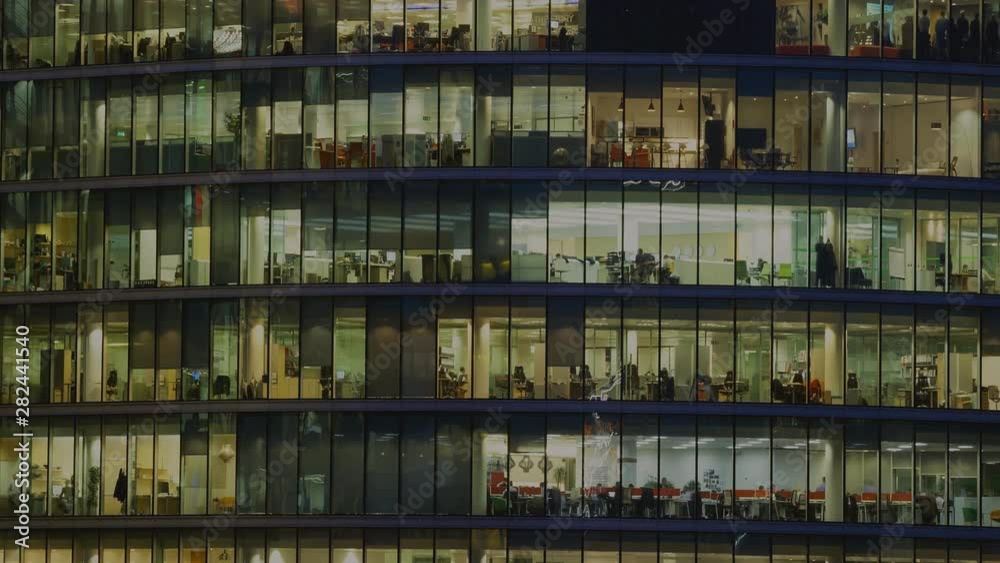 glass office building, workers are seen in the windows (time lapse) glass office building, workers are seen in the windows (time lapse)