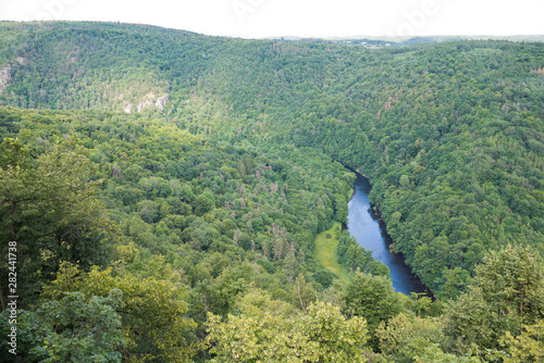 Thaya valley panoramic aerial view of river framed by dense mixed forest and steep rocks.