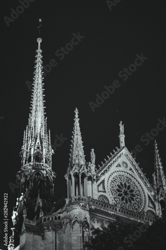 Paris  France  Black and white view of the spire and the top rose window see from the southern facade of the Cathedral of Notre Dame de Paris.