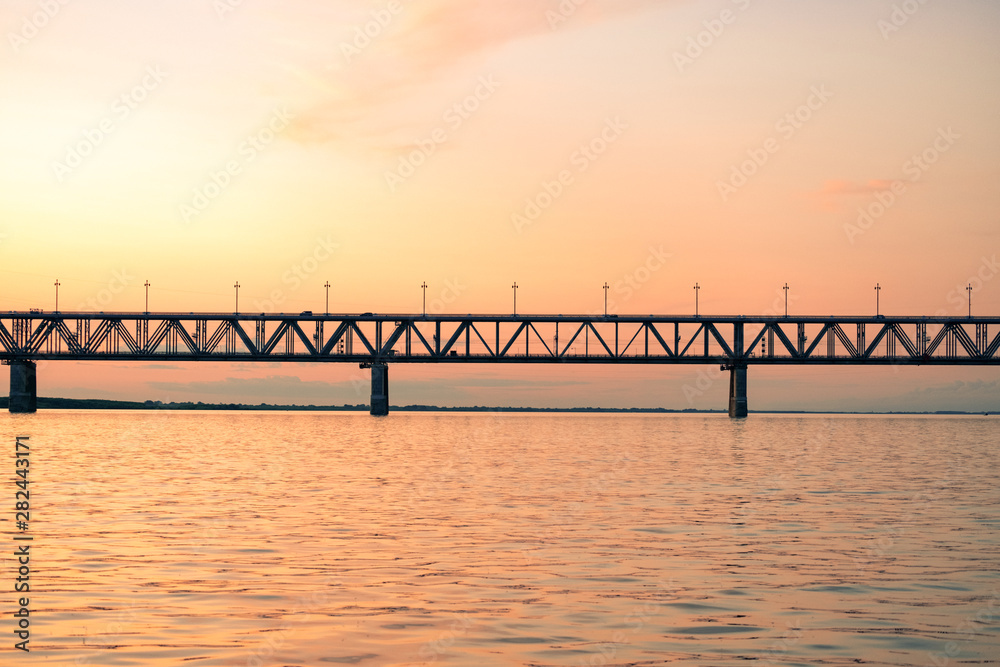 Bridge over the Amur river at sunset. Russia. Khabarovsk. Photo from the middle of the river. Bridge over the Amur river at sunset. Russia. Khabarovsk. Photo from the middle of the river.