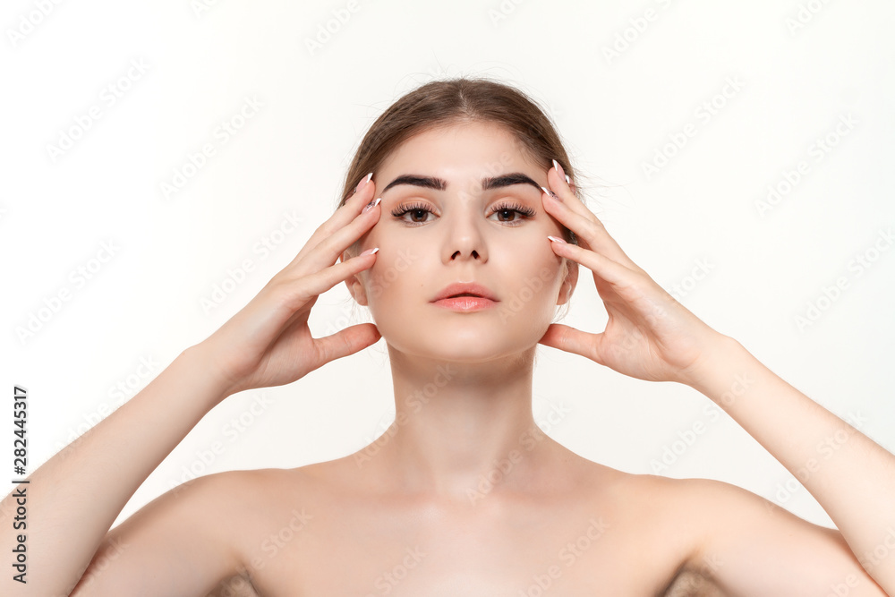 Close-up portrait of a beautiful young girl holding hands near face isolated over white background.