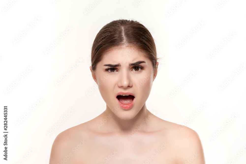 Close-up portrait of a beautiful surprised young girl isolated over white background. Close-up portrait of a beautiful surprised young girl isolated over white background.