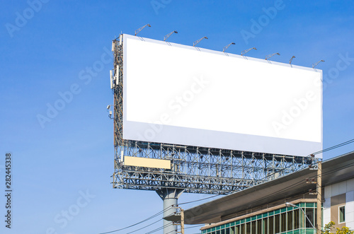 big blank billboard fabric white screen side road on building in city side road. blank ad mockup copy space for advertising banner near bus stop in metropolis.