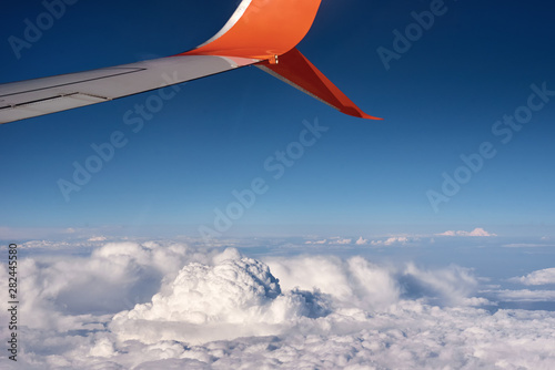 airplane wing and fluffy cloud, view from the airplane window