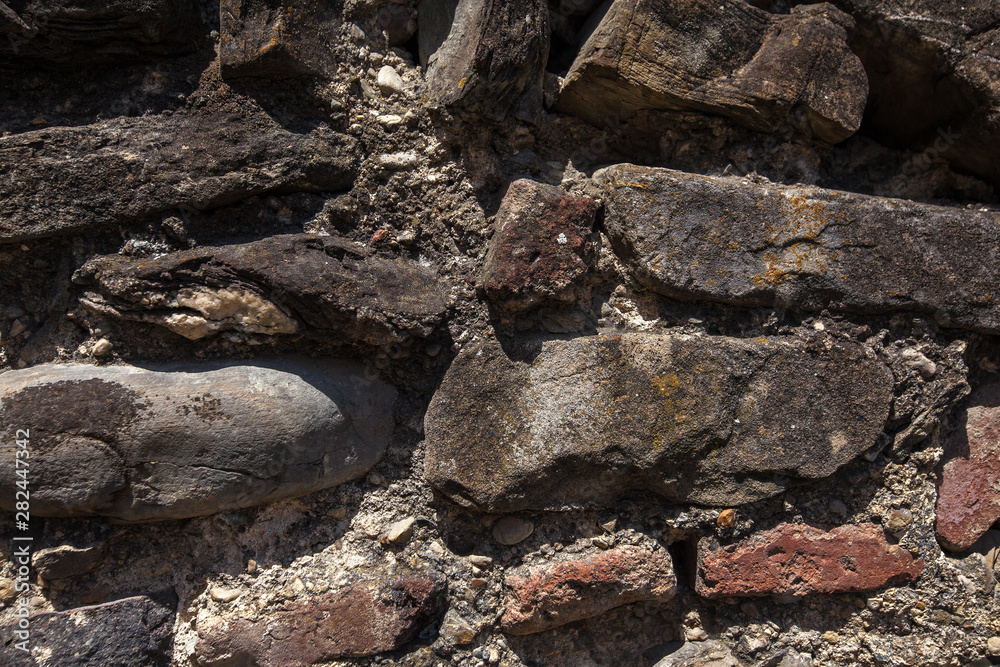 Old cracked stone masonry wall texture