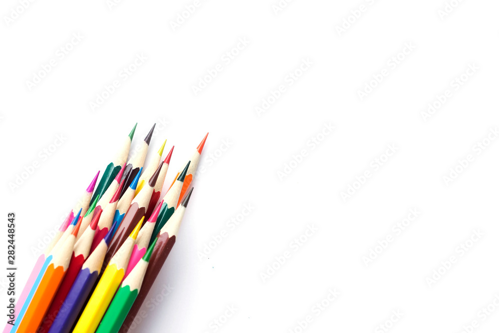 Fototapeta premium Set of school color pencils isolated on white background. Top view, flat lay composition, frame, layout. Copy space for text or design.
