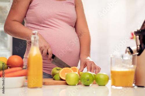 Pregnant woman making juice