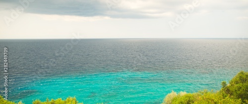 Canvas Print Blue sea and white cloudy sky in an area in Greece Halkidiki