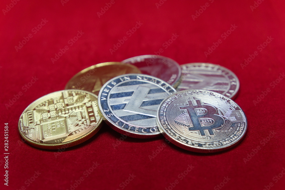 close up of silver and gold cryptocurrency with a red velvet background set up in a circle