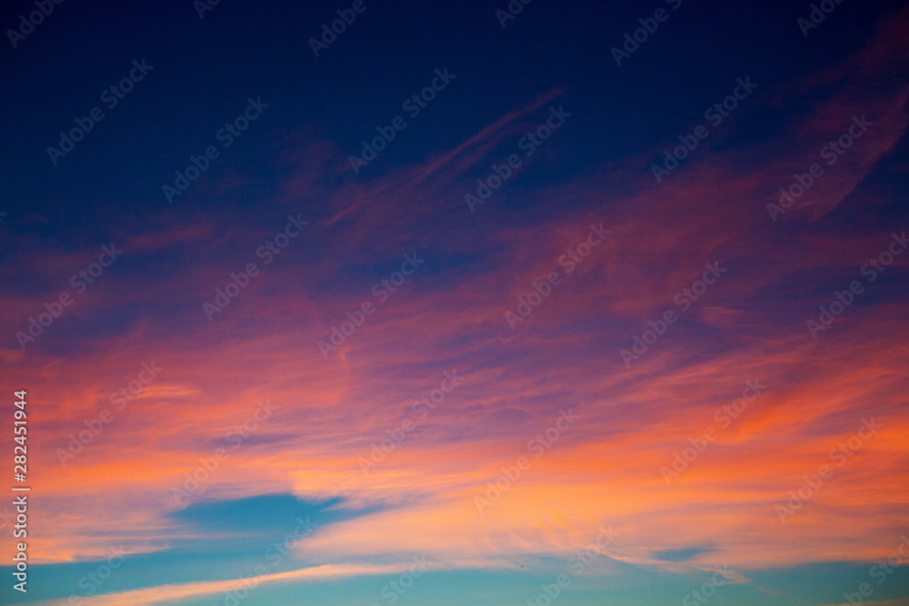 Sunset background with wonderful sky, Amazing purple and orange sky in evening during the sun going down