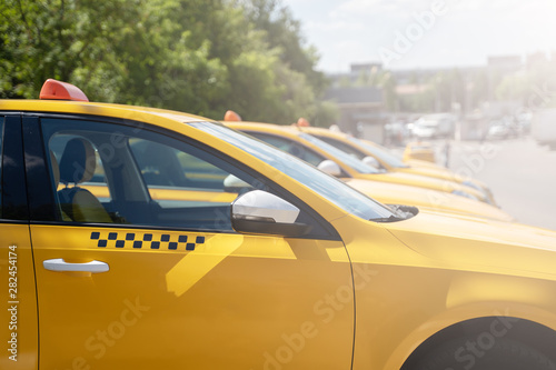 Image of yellow taxi on street in summer