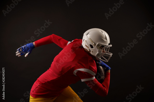 Photo of sporty woman running to right with rugby ball in helmet