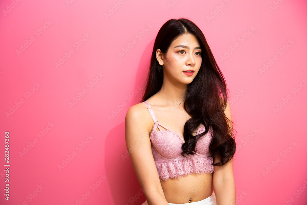 Beautiful young asian girl wearing sexy luxury stylish pink lingerie  relaxing sitting on pink background. asian woman smiling and very happy  Stock Photo | Adobe Stock