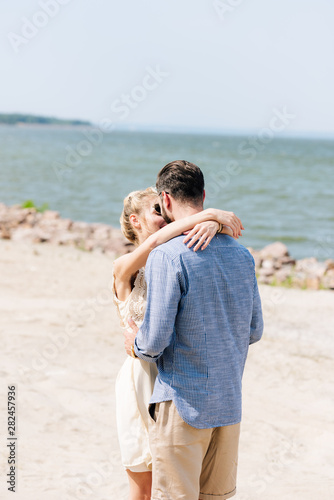 tender couple in love hugging at beach at sunny day