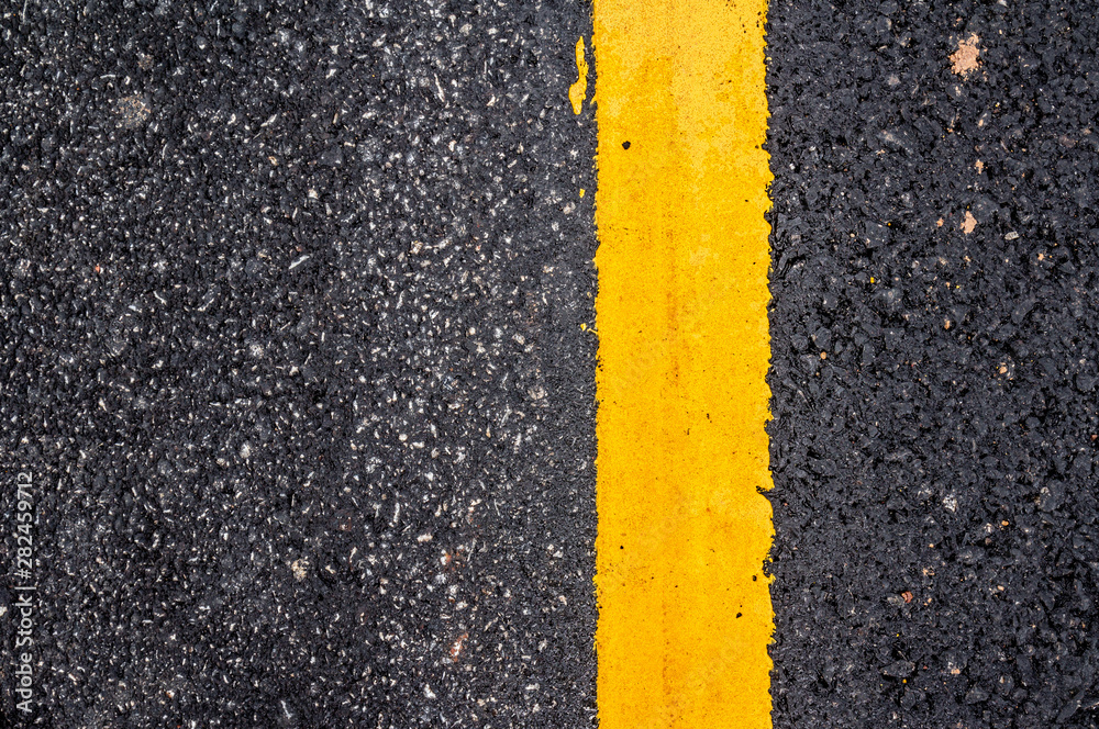 Fototapeta premium Asphalt road surface with yellow line