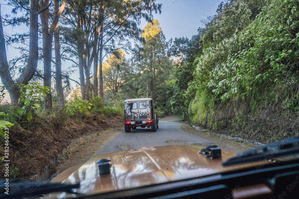 View from the inside of an offroad car riding down the road at the Bromo Tengger Semeru National Park on the Java Island, Indonesia. One of the most famous volcanic objects in the world. Travel to