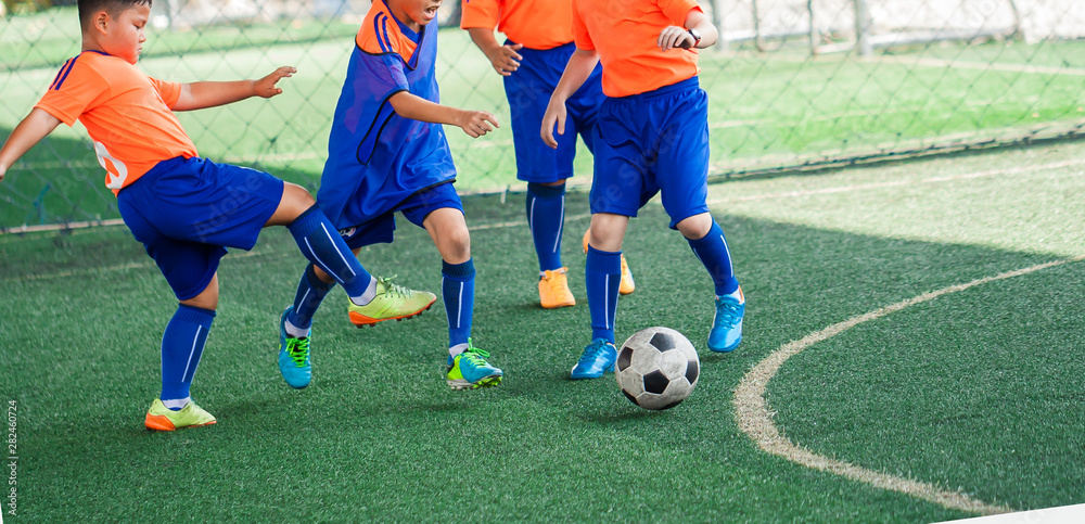 Kid soccer players fighting each other by kicking the ball. Kid soccer players fighting each other by kicking the ball.
